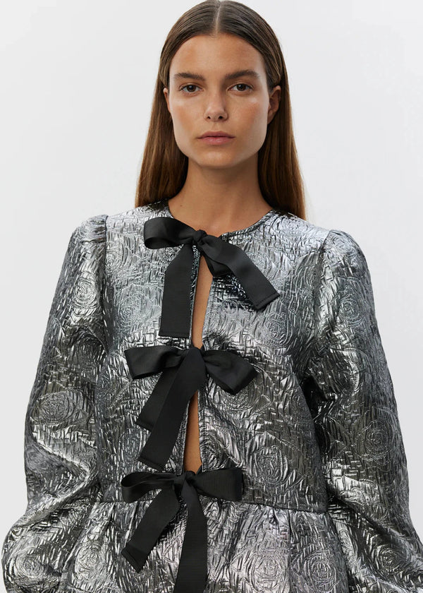shimmery silver blouse with three black bows 