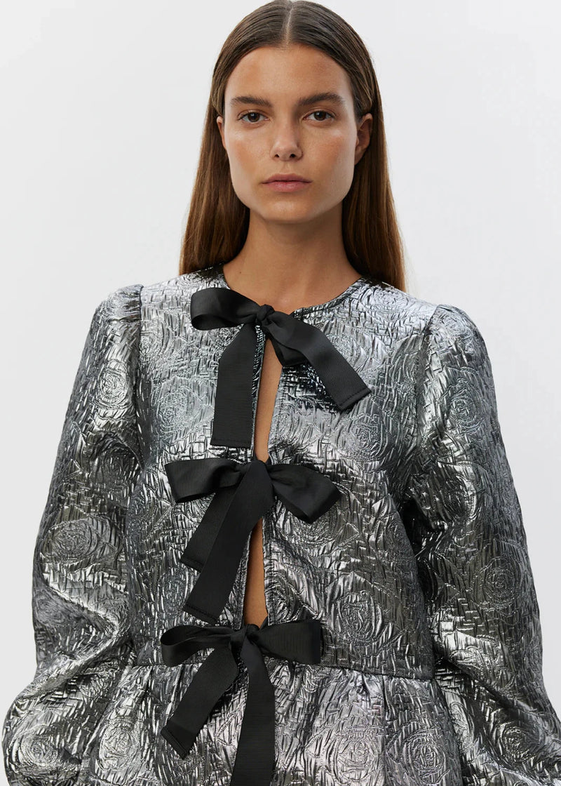 shimmery silver blouse with three black bows 