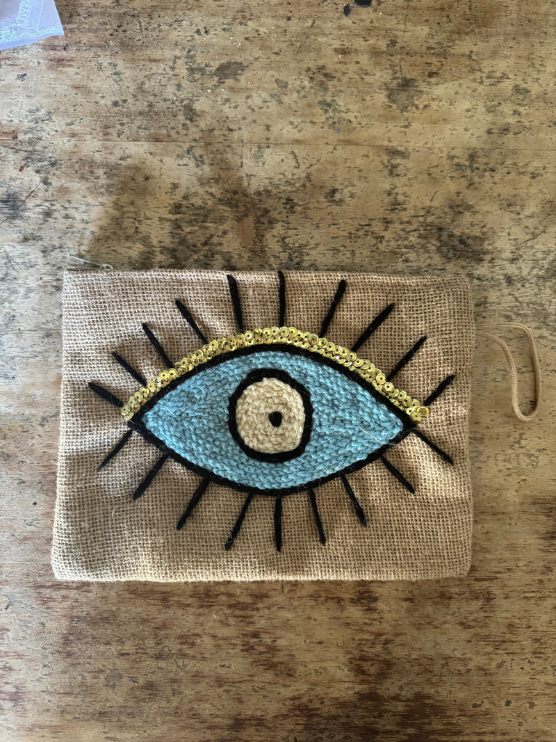 blue and yellow clutch bag with embroidered eye 
