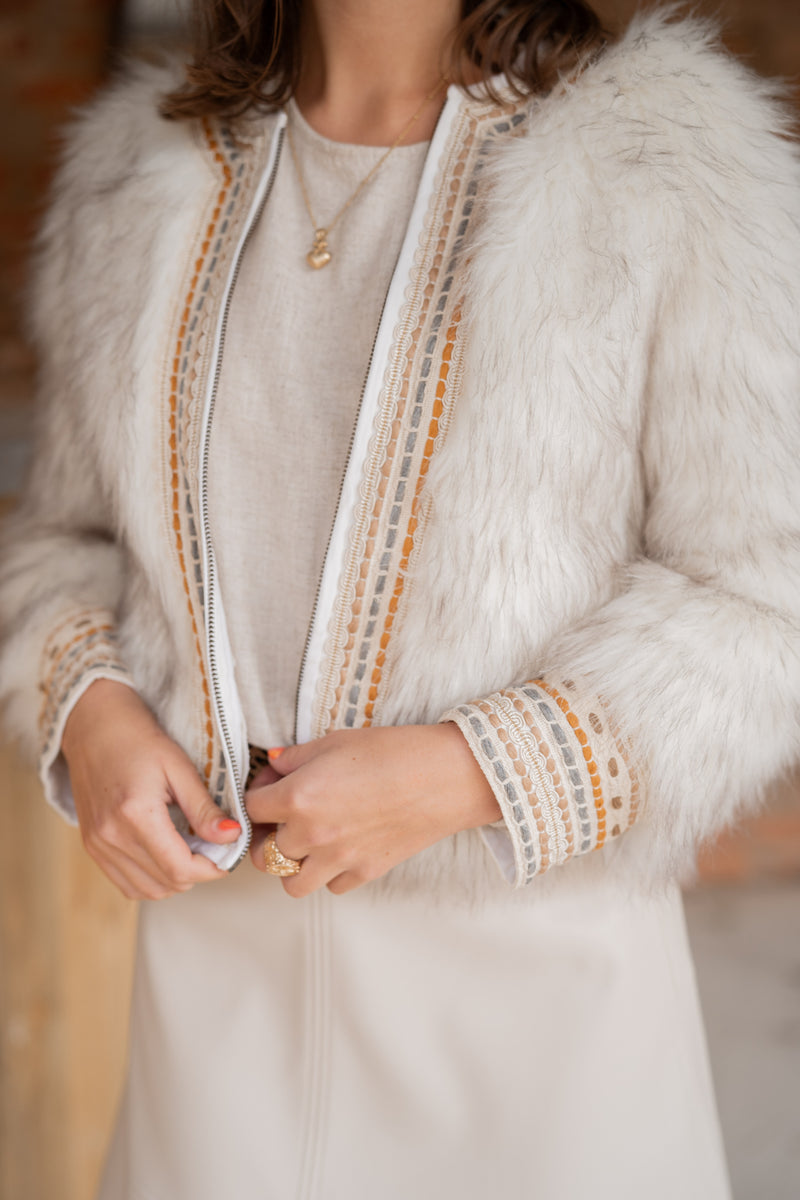 woman wearing sansom reed faux fur statement jacket with embroidery close up 